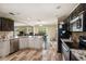 A modern kitchen with stainless steel appliances, dark wood cabinets, granite countertops, and wood-look floors at 13246 Kent Bradley St, Dade City, FL 33525