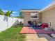 The back patio features a red brick surface, a stylish blue rug, and comfortable seating for outdoor relaxation at 13263 86Th Ave, Seminole, FL 33776