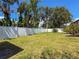 Large backyard with a lush lawn and a white fence, providing ample space for outdoor activities and relaxation at 13263 86Th Ave, Seminole, FL 33776
