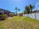 Large backyard with a shed, screened-in patio, and palm trees, creating a serene outdoor space at 13263 86Th Ave, Seminole, FL 33776