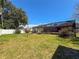 Spacious backyard featuring a screened-in patio with table and chairs for enjoying the outdoors and landscaped plantings at 13263 86Th Ave, Seminole, FL 33776