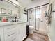 Updated bathroom with modern vanity, stylish mirror, and walk-in shower with black trim at 13263 86Th Ave, Seminole, FL 33776