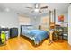 Bedroom featuring hardwood floors, ceiling fan, and large window with natural light at 13263 86Th Ave, Seminole, FL 33776