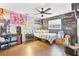 Bedroom with hardwood floors, ceiling fan, and decorated chalkboard paint wall at 13263 86Th Ave, Seminole, FL 33776
