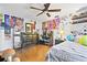 Bedroom with hardwood floors, ceiling fan, and colorful decorations and posters on walls at 13263 86Th Ave, Seminole, FL 33776