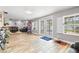 Spacious bonus room with seamless wood look tile flooring, and view to pool and living room at 13263 86Th Ave, Seminole, FL 33776