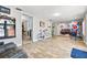 Large bonus room with wood look tile flooring flowing into adjacent living room with open floor plan at 13263 86Th Ave, Seminole, FL 33776