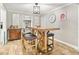 Bright dining area with a high-top table, leather stools, decorative chandelier, and views to adjacent rooms at 13263 86Th Ave, Seminole, FL 33776