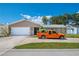 Charming single-story home boasts a manicured lawn, complemented by a two-car garage and spacious driveway at 13263 86Th Ave, Seminole, FL 33776