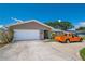 Inviting home with well-maintained lawn, a two-car garage, and ample parking space on the concrete driveway at 13263 86Th Ave, Seminole, FL 33776