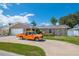 Attractive single-Gathering home featuring a lush green lawn, an attached two-car garage, and a lengthy driveway at 13263 86Th Ave, Seminole, FL 33776