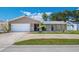 A well kept home offers a manicured lawn, two-car garage, and a paved driveway for additional parking at 13263 86Th Ave, Seminole, FL 33776