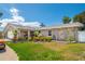 Beautifully landscaped front yard, with stone accents and colorful flowerbeds, enhances the curb appeal of this home at 13263 86Th Ave, Seminole, FL 33776