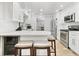 Modern kitchen with white countertops, stainless steel appliances, barstool seating, and wooden floors at 13263 86Th Ave, Seminole, FL 33776