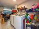 Well-equipped laundry room featuring modern washer and dryer, complemented by stylish flooring and functional storage at 13263 86Th Ave, Seminole, FL 33776