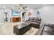 Inviting living room featuring wood-look tile floors, ceiling fan, comfortable seating, and a decorative octopus wall-hanging at 13263 86Th Ave, Seminole, FL 33776