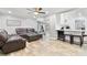 Open-concept living room featuring hardwood floors and a view into the modern kitchen with bar seating at 13263 86Th Ave, Seminole, FL 33776