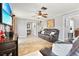 Inviting living room features wood-look tile floors, ceiling fan, comfortable seating, and easy access to other spaces at 13263 86Th Ave, Seminole, FL 33776