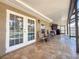 Covered patio with seating, a grill, and views of the pool, creating a relaxing and inviting outdoor space at 13263 86Th Ave, Seminole, FL 33776