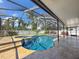 Beautiful screened-in pool with a hot tub, paver patio and lush landscaping creating a relaxing backyard oasis at 13263 86Th Ave, Seminole, FL 33776
