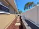 Narrow side yard with a gravel walkway, providing access along the house and leading to a backyard at 13263 86Th Ave, Seminole, FL 33776