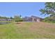 View of the backyard showcasing a screened pool and green grass at 14502 Pond Cypress Way, Tampa, FL 33626