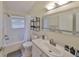 Bright bathroom featuring a shower-tub combo and vanity with a large, well-lit mirror at 14502 Pond Cypress Way, Tampa, FL 33626