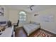 Bedroom with hardwood floors, ceiling fan, and a whiteboard for studying at 14502 Pond Cypress Way, Tampa, FL 33626