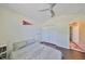 Bedroom with hardwood floors, ceiling fan, and a large closet for storage at 14502 Pond Cypress Way, Tampa, FL 33626