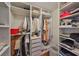 Organized walk-in closet with ample shelving and storage for clothing and accessories at 14502 Pond Cypress Way, Tampa, FL 33626