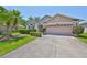 Well-maintained single-Gathering home with neat landscaping and a two-car garage at 14502 Pond Cypress Way, Tampa, FL 33626