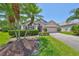 Charming single-story home with manicured front yard and lush palm trees at 14502 Pond Cypress Way, Tampa, FL 33626