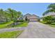 Inviting single-Gathering home with lush landscaping, healthy green lawn, and a two-car garage at 14502 Pond Cypress Way, Tampa, FL 33626