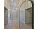 Bright entryway hallway with tile flooring and arched ceiling at 14502 Pond Cypress Way, Tampa, FL 33626