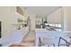 Modern white kitchen with stainless steel appliances, bar seating, and ample counter space at 14502 Pond Cypress Way, Tampa, FL 33626