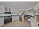 Well-equipped kitchen features stainless steel appliances and white cabinetry at 14502 Pond Cypress Way, Tampa, FL 33626