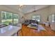 Bright living room with hardwood floors, neutral decor, and large windows overlooking the backyard at 14502 Pond Cypress Way, Tampa, FL 33626