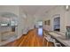 Open-concept living area showcasing hardwood floors, arched doorways, and ample natural light at 14502 Pond Cypress Way, Tampa, FL 33626
