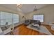 Bright living room features hardwood floors, stylish lighting and a comfortable gray leather sectional at 14502 Pond Cypress Way, Tampa, FL 33626