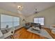 Bright living room features hardwood floors, stylish lighting and a comfortable gray leather sectional at 14502 Pond Cypress Way, Tampa, FL 33626