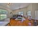 Cozy living room area featuring hardwood floors, vaulted ceiling, and natural light at 14502 Pond Cypress Way, Tampa, FL 33626