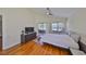 Comfortable bedroom with hardwood floors, ceiling fan, and glass doors to the patio at 14502 Pond Cypress Way, Tampa, FL 33626