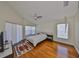 Spacious main bedroom with hardwood floors, ceiling fan, and light neutral walls at 14502 Pond Cypress Way, Tampa, FL 33626
