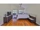 Bright main bedroom with hardwood floors, ceiling fan, and sliding glass doors to the patio at 14502 Pond Cypress Way, Tampa, FL 33626