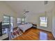 Spacious bedroom with hardwood floors, high ceilings, and sliding glass doors to the pool area at 14502 Pond Cypress Way, Tampa, FL 33626