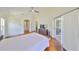 Bright main bedroom with hardwood floors, ensuite bathroom, and doors to the patio at 14502 Pond Cypress Way, Tampa, FL 33626