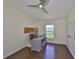 Spacious office with a modern ceiling fan, desk, and bright window views at 14502 Pond Cypress Way, Tampa, FL 33626