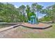 A well-maintained community playground with modern play equipment and a safe, wood-chip ground cover at 14502 Pond Cypress Way, Tampa, FL 33626