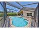 The screened-in pool and patio area creates a serene retreat with clear blue waters and lush greenery at 14502 Pond Cypress Way, Tampa, FL 33626