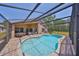 The screened-in pool is surrounded by ample seating, perfect for outdoor living and relaxation at 14502 Pond Cypress Way, Tampa, FL 33626
